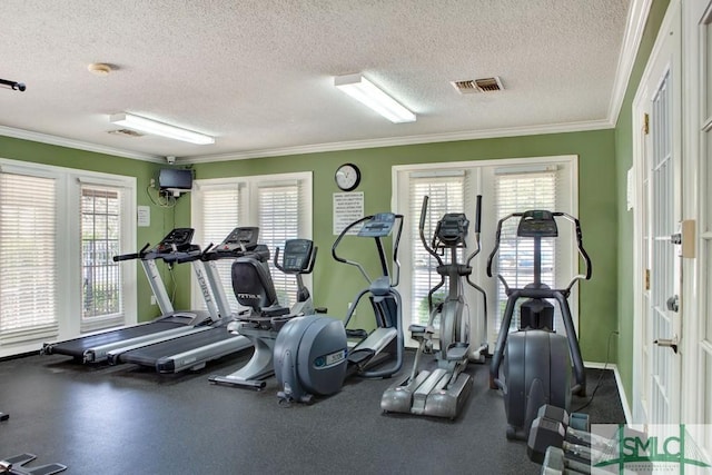 exercise room featuring visible vents, a textured ceiling, and crown molding