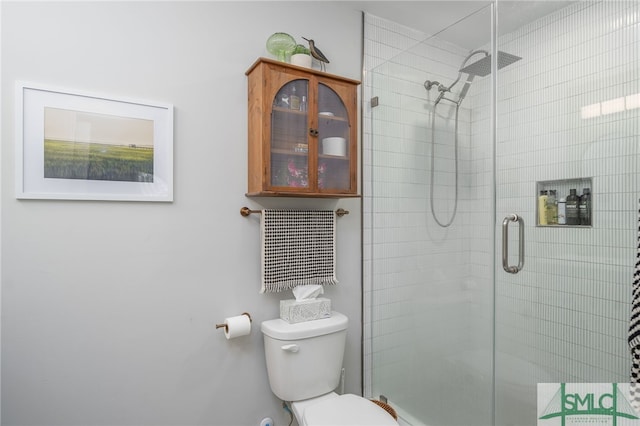 full bathroom featuring a stall shower and toilet