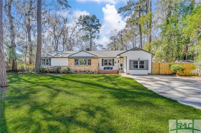 single story home with a front lawn and fence