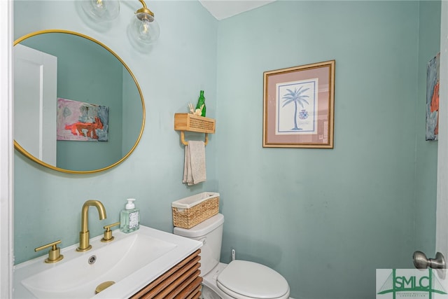 half bathroom featuring toilet and vanity