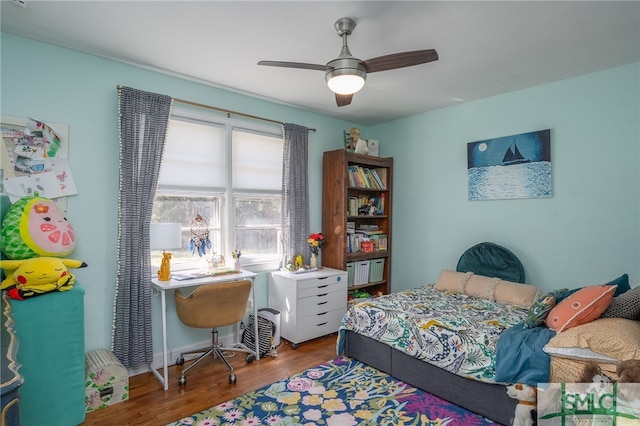 bedroom featuring a ceiling fan and wood finished floors