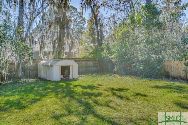 view of yard featuring an outdoor structure, a storage shed, and a fenced backyard