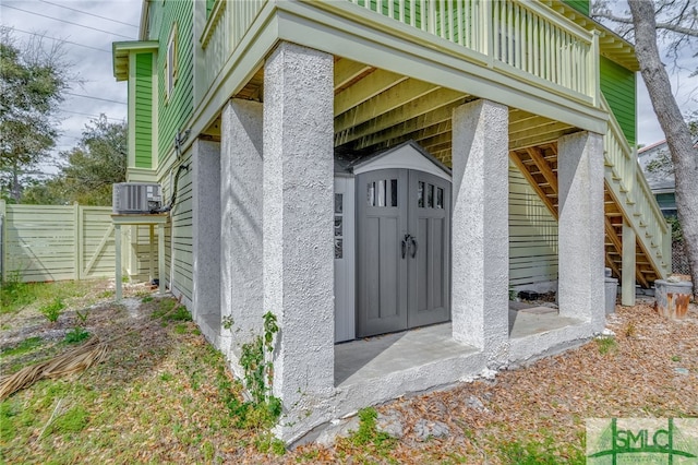 entrance to property with central AC unit and fence