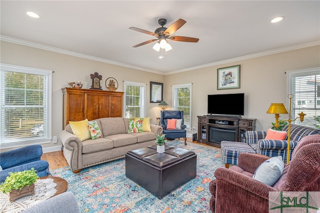 living area with a ceiling fan, recessed lighting, wood finished floors, and ornamental molding