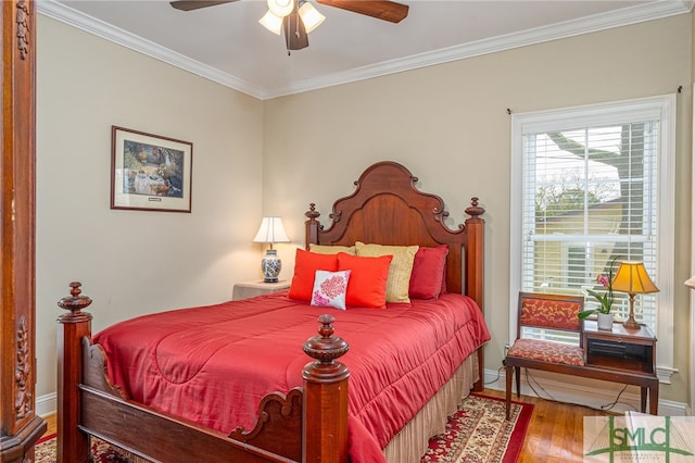 bedroom with ceiling fan, crown molding, baseboards, and wood finished floors