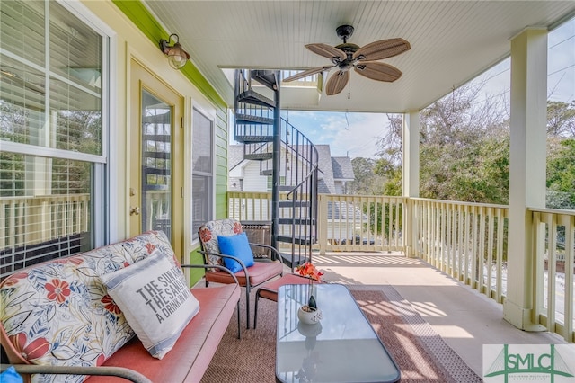 view of patio / terrace with ceiling fan and stairs