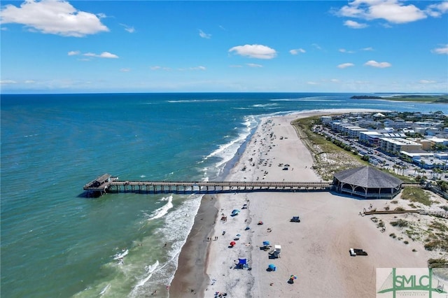 birds eye view of property with a water view and a view of the beach