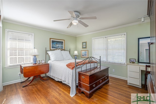 bedroom with ceiling fan, baseboards, wood finished floors, and crown molding