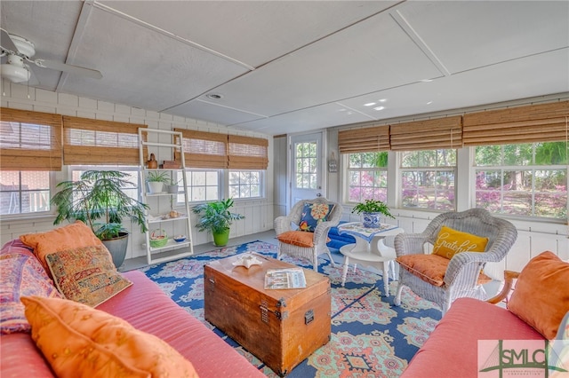 sunroom featuring a ceiling fan