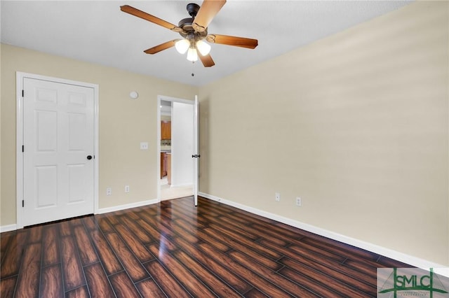 unfurnished bedroom featuring ceiling fan, baseboards, and dark wood-style floors