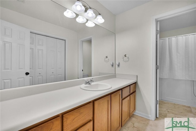 bathroom with vanity and baseboards