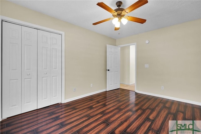 unfurnished bedroom with ceiling fan, a closet, baseboards, and wood finished floors