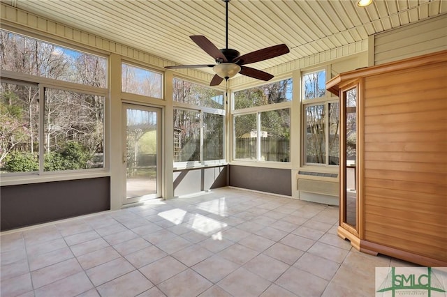 unfurnished sunroom with plenty of natural light, wood ceiling, and ceiling fan