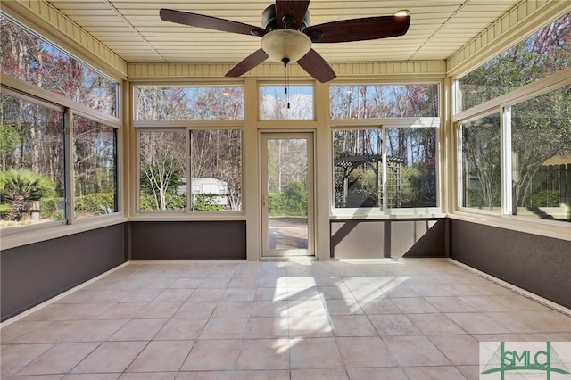 unfurnished sunroom featuring plenty of natural light and a ceiling fan