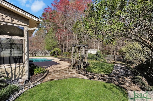 view of pool featuring fence, a fenced in pool, and a lawn