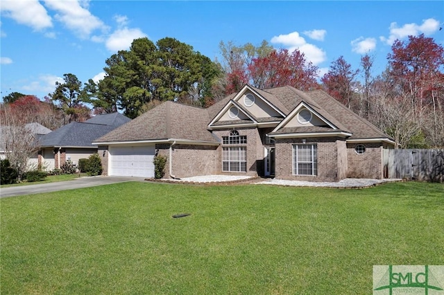 view of front of property featuring driveway, a front lawn, fence, an attached garage, and brick siding