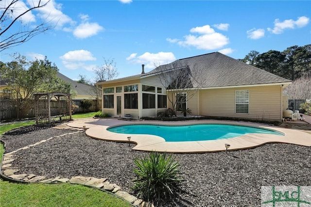 view of pool featuring a patio, a fenced in pool, fence, and a sunroom