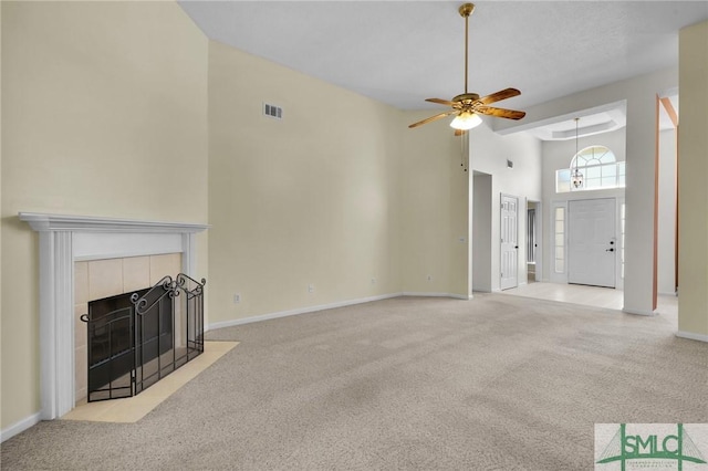 unfurnished living room with a ceiling fan, carpet, visible vents, and a fireplace