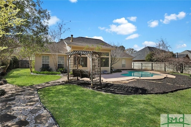 back of property with a lawn, a pergola, a patio, a fenced backyard, and a fenced in pool