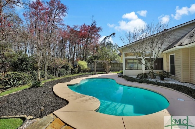 view of swimming pool with fence and a fenced in pool