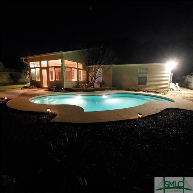 pool at twilight featuring an outdoor pool