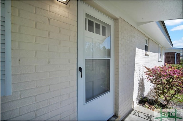 entrance to property with brick siding