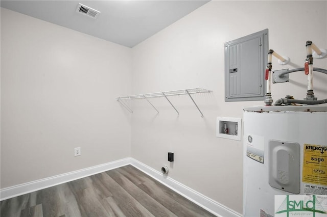 clothes washing area with dark wood-type flooring, water heater, laundry area, hookup for a washing machine, and electric panel