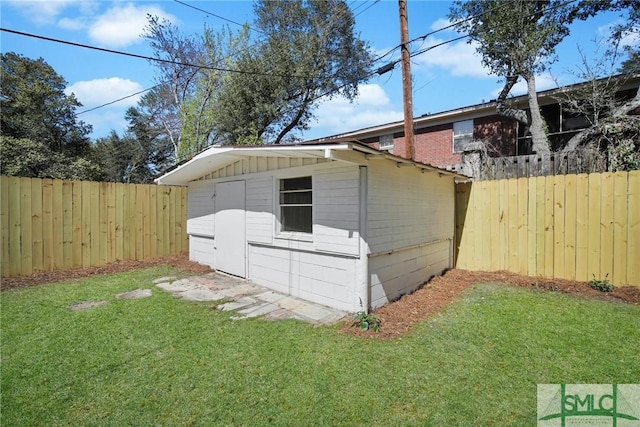 view of yard with an outbuilding and a fenced backyard