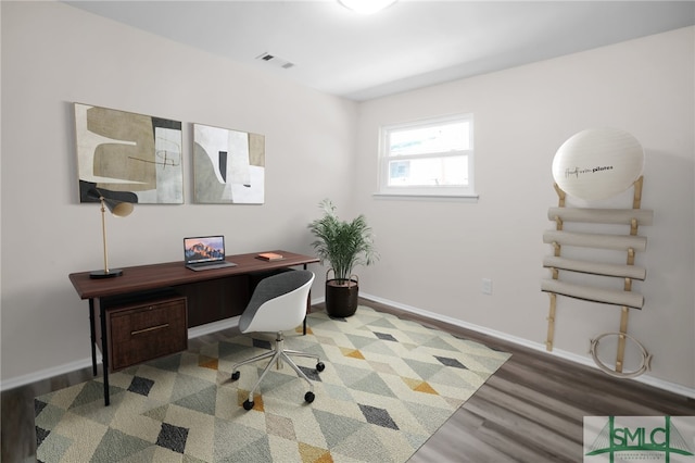 home office featuring visible vents, wood finished floors, and baseboards