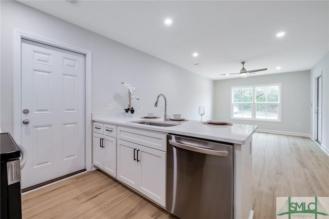 kitchen with light wood-type flooring, a peninsula, stainless steel dishwasher, white cabinets, and a sink