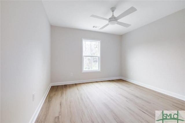 unfurnished room with visible vents, ceiling fan, baseboards, and wood finished floors