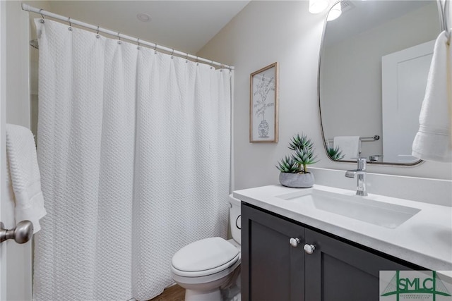 bathroom featuring vanity and toilet