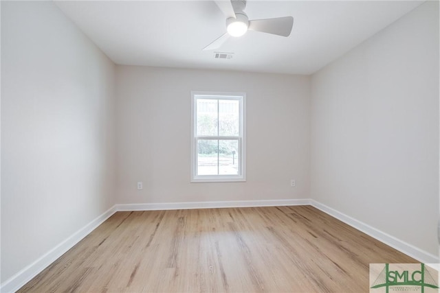 spare room featuring ceiling fan, baseboards, visible vents, and light wood-type flooring