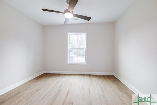 empty room featuring baseboards, wood finished floors, and a ceiling fan