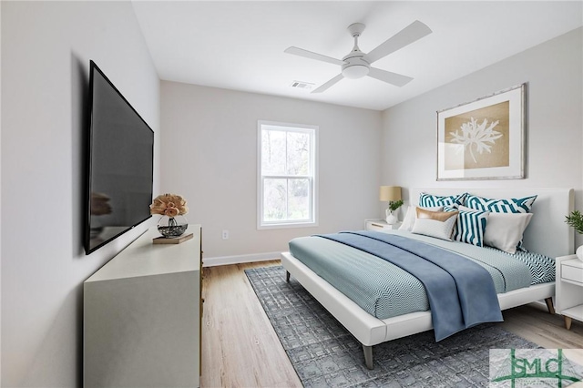 bedroom with visible vents, ceiling fan, baseboards, and wood finished floors