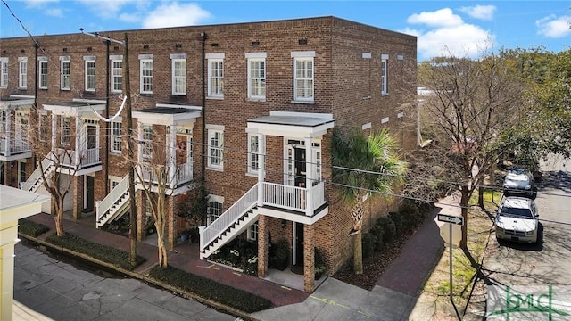 multi unit property featuring brick siding and stairway