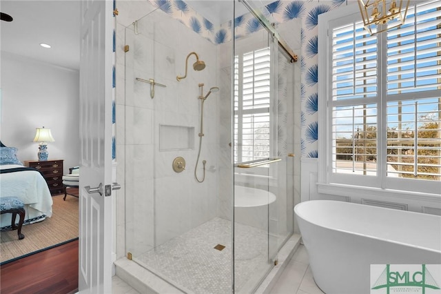 full bath with a freestanding tub, wainscoting, a stall shower, and connected bathroom