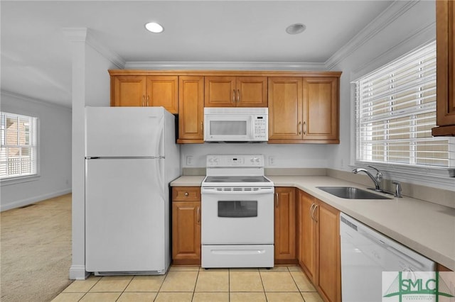 kitchen with a wealth of natural light, ornamental molding, a sink, white appliances, and light tile patterned floors