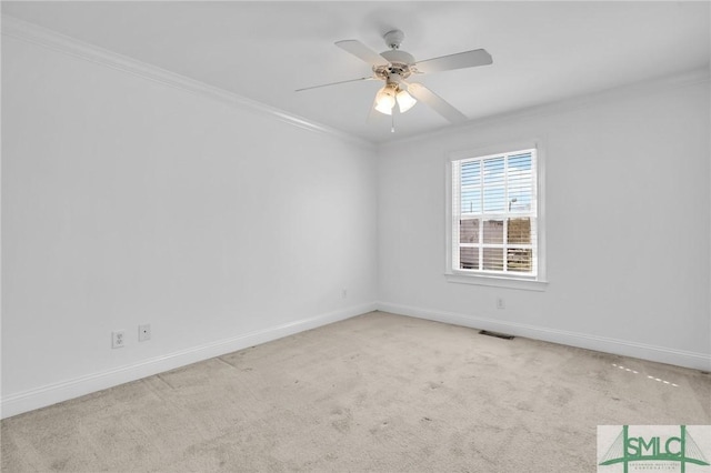 unfurnished room with baseboards, visible vents, ceiling fan, ornamental molding, and carpet flooring