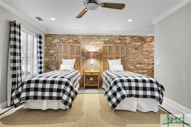 bedroom featuring visible vents, brick wall, crown molding, and baseboards