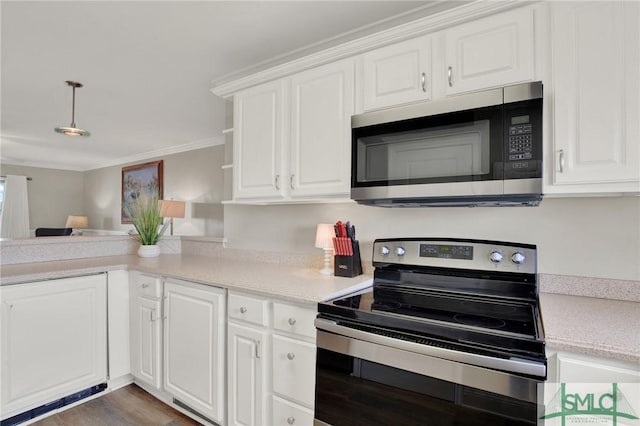 kitchen featuring decorative light fixtures, light countertops, ornamental molding, stainless steel appliances, and white cabinetry