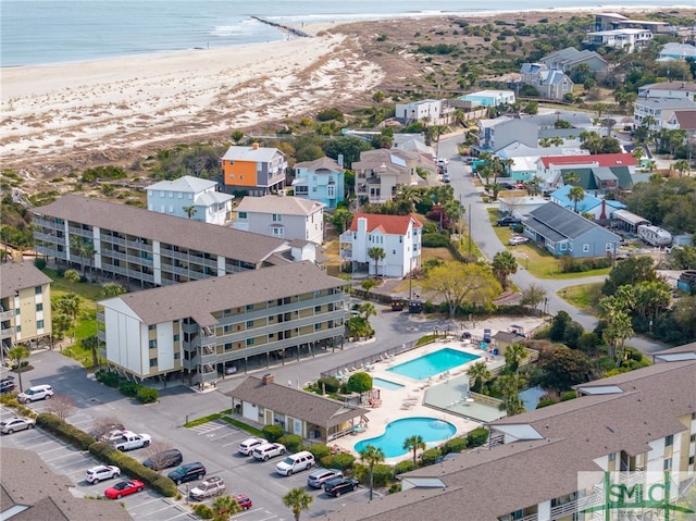 birds eye view of property featuring a view of the beach and a water view