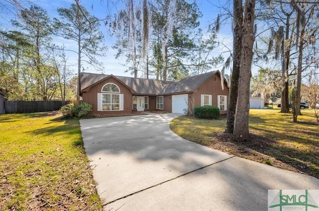 ranch-style home with a garage, driveway, a front yard, and fence