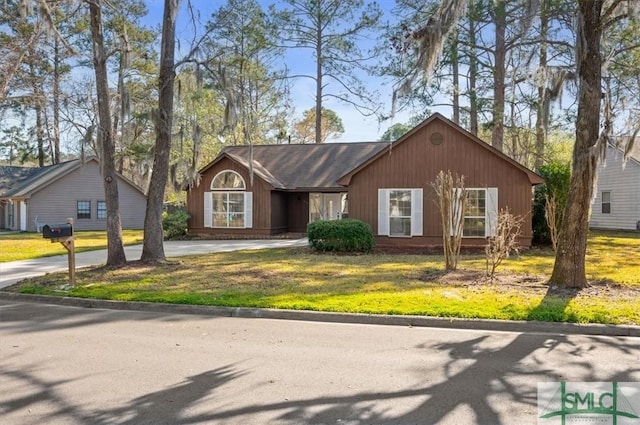 view of front of property with a front yard and driveway