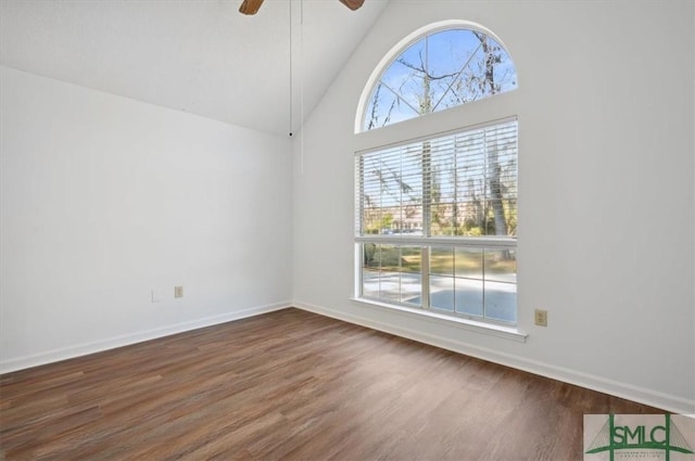 unfurnished room featuring baseboards, high vaulted ceiling, ceiling fan, and wood finished floors