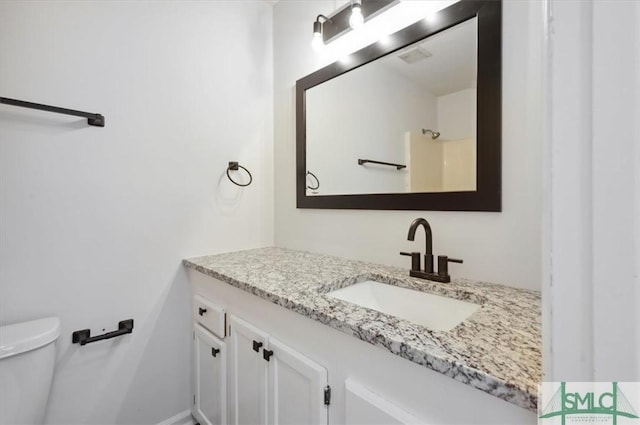 bathroom with toilet and vanity