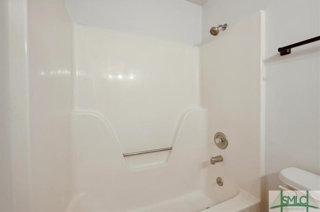 bathroom with toilet and  shower combination