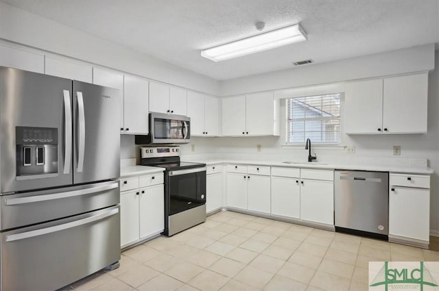 kitchen featuring light countertops, visible vents, appliances with stainless steel finishes, and a sink