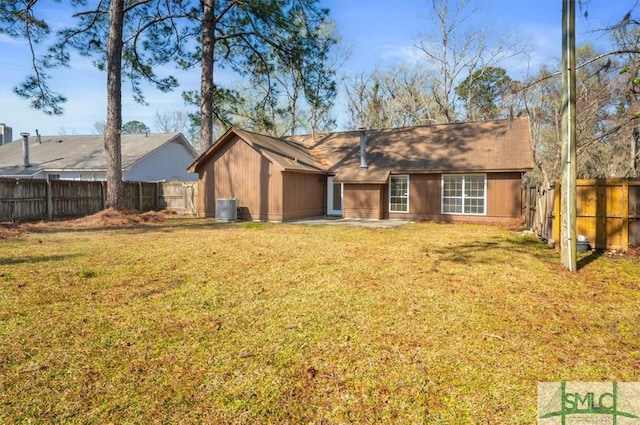 back of property featuring central AC unit, a lawn, and a fenced backyard