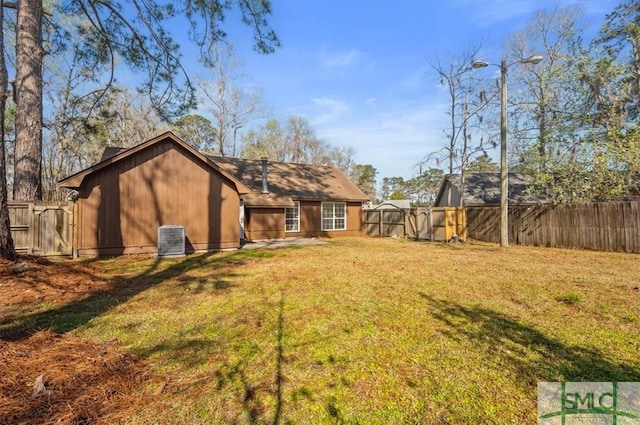 view of yard featuring central air condition unit and a fenced backyard